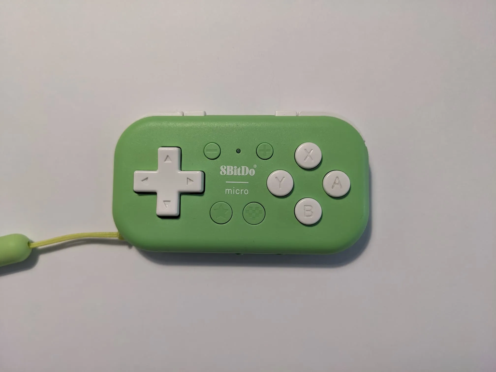 green 8bitdo micro. it's a controller with shoulder buttons, a d-pad on the left, the 4 ABXY buttons on the right, and some smaller buttons in between for select/start/turbo/home